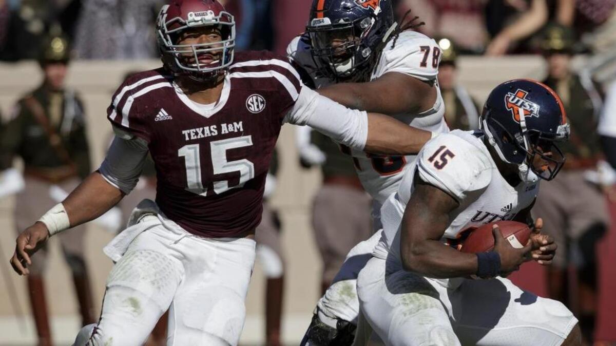 Texas A&M defensive lineman Myles Garrett (15) makes a one-handed sack as he pulls down UTSA quarterback Jared Johnson (15) during the third quarter of an NCAA college football game Saturday, Nov. 19, 2016, in College Station, Texas.
