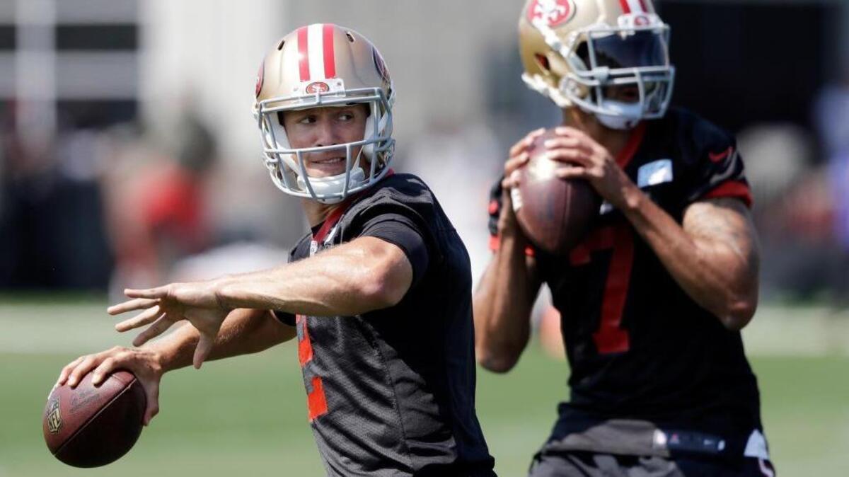 San Francisco 49ers quarterbacks Blaine Gabbert, left, and Colin Kaepernick throw during NFL football training camp Sunday, July 31, 2016, in Santa Clara, Calif.