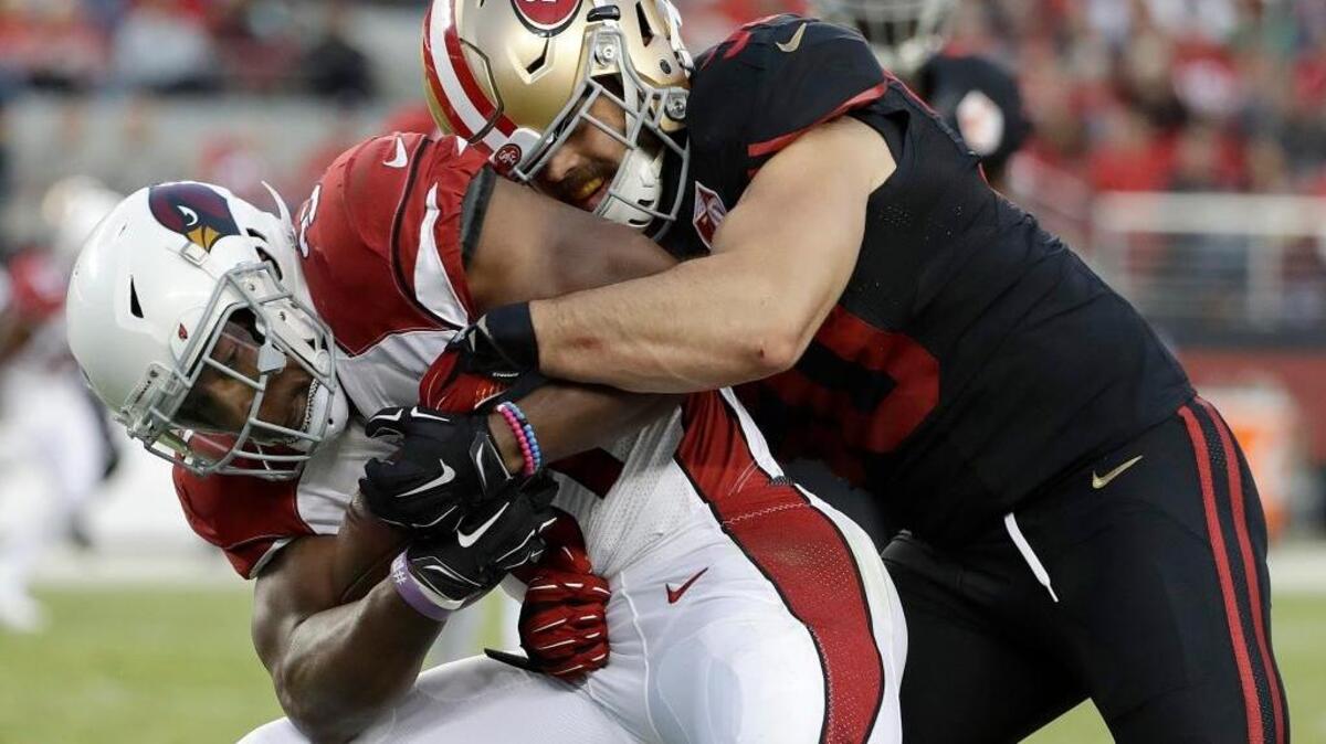 San Francisco 49ers linebacker Nick Bellore, right, tackles Arizona Cardinals running back David Johnson during the first half of an NFL football game in Santa Clara, Calif., Thursday, Oct. 6, 2016.