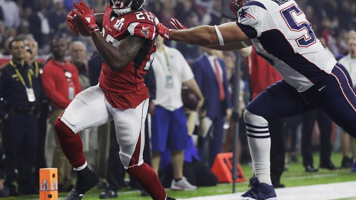 The Atlanta Falcons’ Tevin Coleman, left, scores past the New England Patriots’ Rob Ninkovich during the second half of Super Bowl 51 on Sunday, Feb. 5, 2017, in Houston.