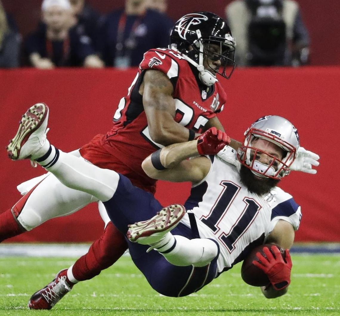 The New England Patriots’ Julian Edelman is tackled by the Atlanta Falcons’ Robert Alford during the first half of Super Bowl 51 on Sunday, Feb. 5, 2017, in Houston.