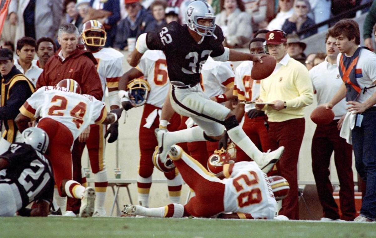SUPER BOWL XVIII: Marcus Allen, Los Angeles Raiders – Allen high-steps his way down the sideline past the Washington Redskins’ Anthony Washington (24) and Todd Bowles (28) on Jan. 22, 1984, in Tampa, Fla. Allen helped the AFC champions win 38-9.