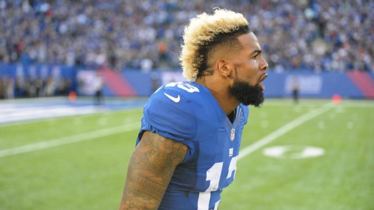New York Giants wide receiver Odell Beckham celebrates after scoring a touchdown during an NFL football game against the Baltimore Ravens Sunday, Oct. 16, 2016, in East Rutherford, N.J. He was fined for removing his helmet as part of his celebration, which is a violation of NFL rules.