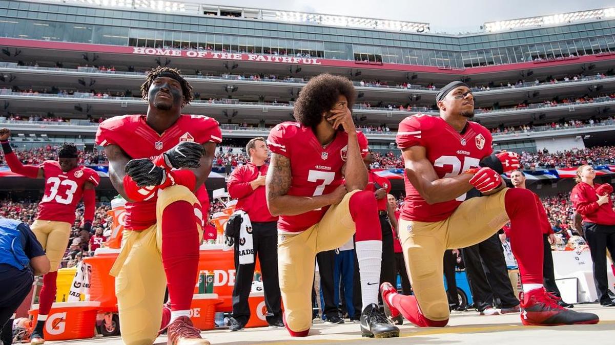 San Francisco quarterback Colin Kaepernick (7) kneels with teammates Eli Harold, left, and Eric Reid before a game at at Levi’s Stadium on Sunday Oct. 2, 2016 in Santa Clara, Calif