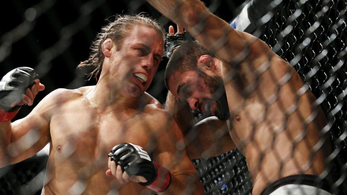 Urijah Faber, left, fights Frankie Saenz at UFC 194 on Dec. 12, 2015, in Las Vegas. Faber faces Jimmie Rivera in UFC 203 Saturday in Cleveland.