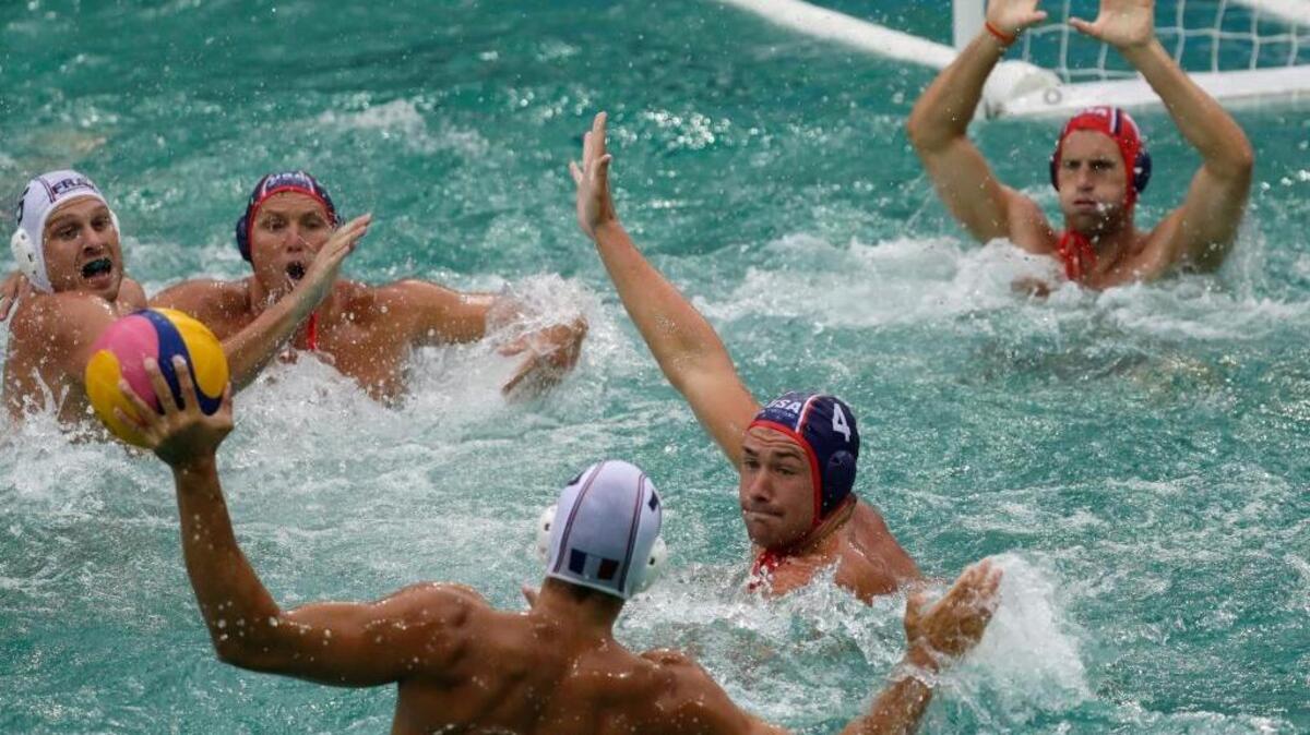 France’s Ugo Crousillat takes a shot as the United States’ Alex Obert defends during Wednesday’s men’s water polo preliminary round match at the 2016 Summer Olympics in Rio de Janeiro, Brazil.