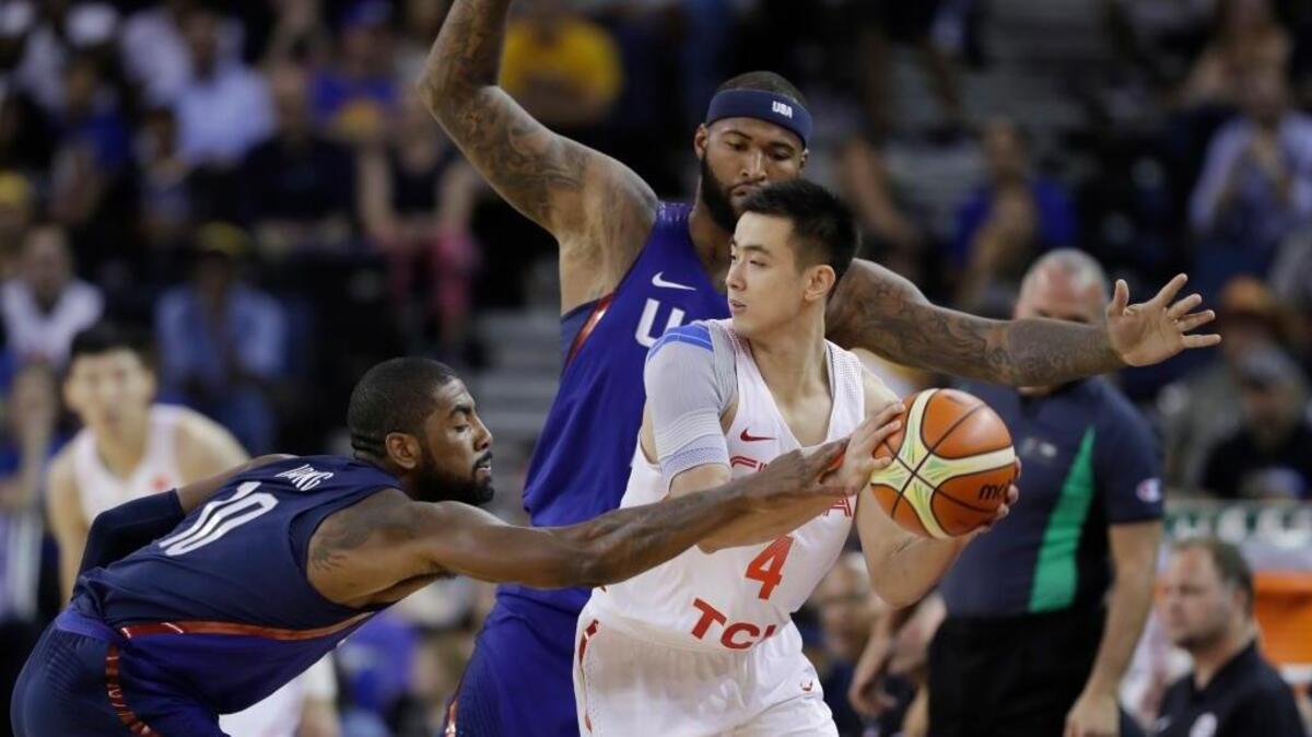 China’s Zhao Jiwei is defended by United States’ Kyrie Irving, left, and DeMarcus Cousins during the first half of an exhibition game Tuesday, July 26, 2016, in Oakland.