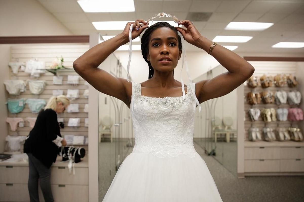 Shevon Stoddart, a 34-year-old Jamaican hurdler, tries on a tiara while getting her wedding dress fitted in June ahead of her July 22 wedding with two-time Olympic high jumper Jamie Nieto, who is recovering from a spinal cord injury.