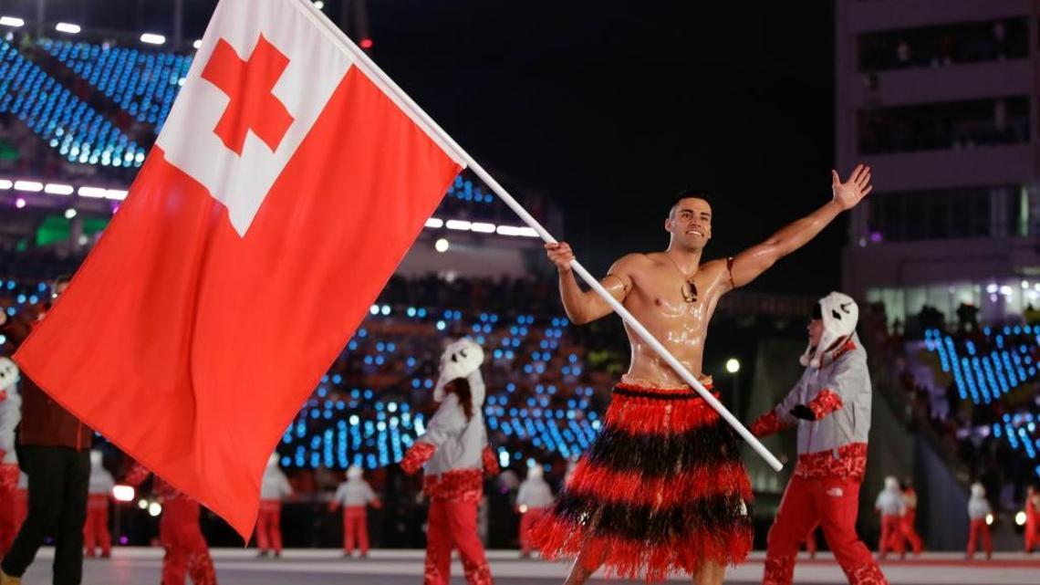 Pita Taufatofua carries the flag of Tonga during the opening ceremony of the 2018 Winter Olympics in Pyeongchang, South Korea, Friday, Feb. 9, 2018.