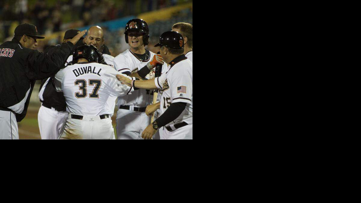 
Sacramento River Cats first baseman Adam Duvall (37) is mobbed by teammates after hitting a solo homer to give the River Cats a 1-0 victory on Thursday, April 9, 2015 on Opening Day between the Sacramento River Cats and Salt Lake City Bees at Raley Field in West Sacramento.

