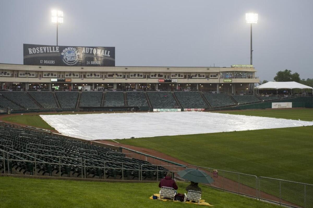 Garrick McCall, left, and his father, Galen McCall, were prepared to watch their 17th consecutive Sacramento River Cats home opener in 2017 before rain postponed the game. Rain is forecast for Sacramento on Monday, March 31, during the Athletics Opening Day at Sutter Health Park.