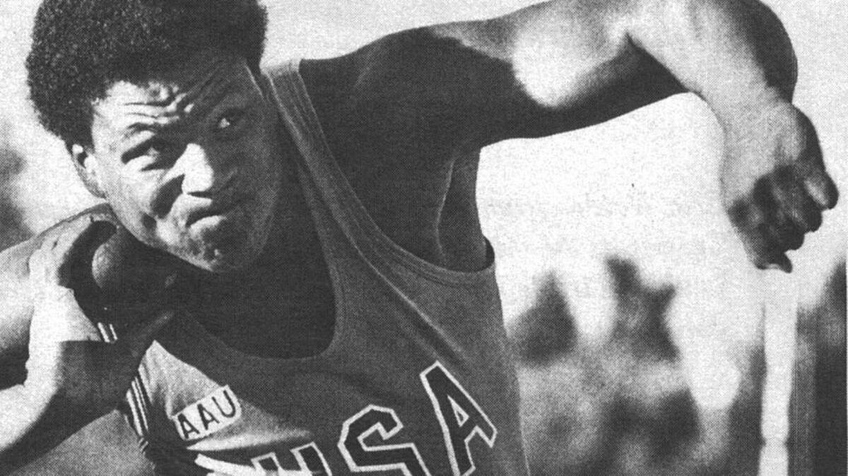 Michael Carter competes in the shot put at the Golden West Invitational in 1979 at Sacramento State, where Carter set a national high school record by throwing 81 feet, 3 1/2 inches.