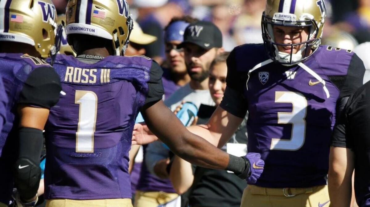 Washington quarterback Jake Browning, right, greets wide receiver John Ross on the sideline after Ross scored a touchdown on a pass from Browning against Idaho in the first half of an NCAA college football game Saturday, Sept. 10, 2016, in Seattle. The former Folsom High School standout threw for five scores.