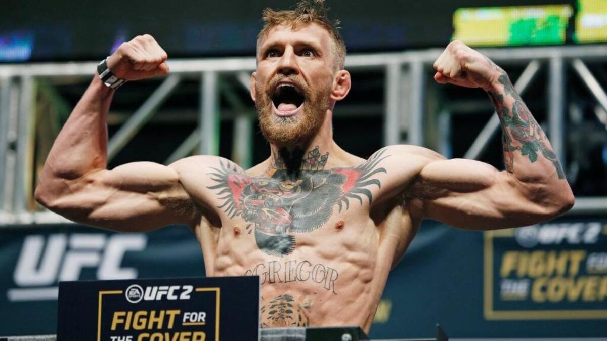 Conor McGregor poses on the scale during the weigh-in for UFC 194 in Las Vegas on Dec. 11, 2015. McGregor is a featherweight champion fighting a lightweight opponent at the welterweight limit Saturday, March 5, 2016, at UFC 196. Yet the charismatic Irish superstar doesn’t consider this unusual matchup with late replacement Nate Diaz to be particularly dangerous or daunting.