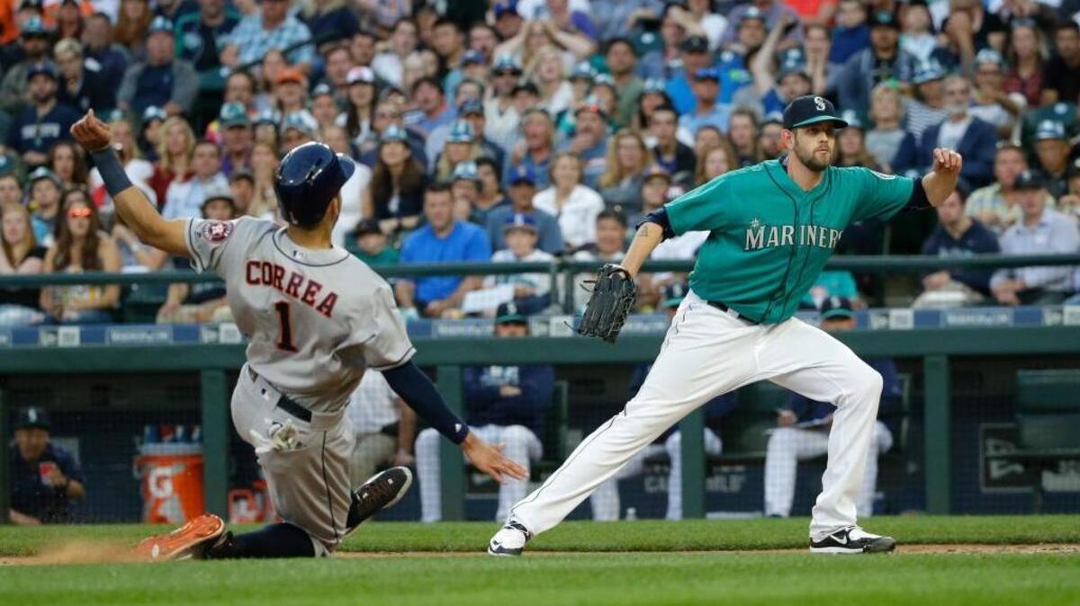 Carlos Correa scores on a wild pitch by James Paxton, right, in the Astros’ 7-3 victory over the Mariners on Friday, July 15, 2016, in Seattle.