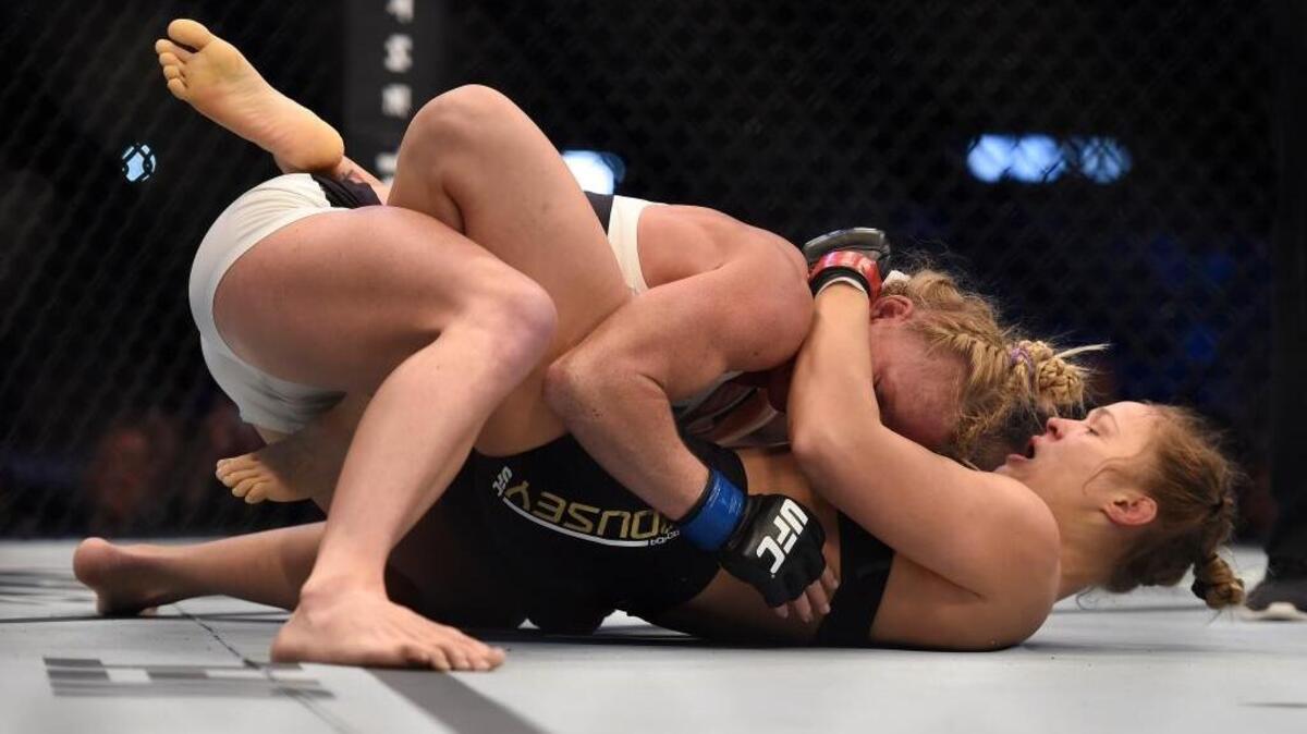 Holly Holm, left wrestles Ronda Rousey during thier UFC 193 Bantamweight title fight in Melbourne, Australia, Sunday, Nov. 15, 2015.