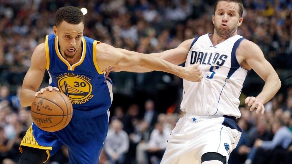 The Warriors’ Stephen Curry drives around Mavericks guard J.J. Barea in the second half Friday, March 18, 2016, in Dallas. Golden State won 130-112.