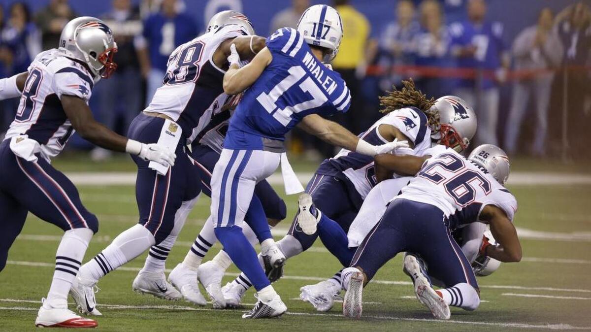 Colts wide receiver Griff Whalen (17) watches as teammate, free safety Colt Anderson, is swarmed under by Patriots defenders during a botched fake punt in the third quarter of an NFL football game in Indianapolis, Sunday, Oct. 18, 2015. Whalen served as the center on the play, and curiously enough, was unable to block three Patriots by himself.

