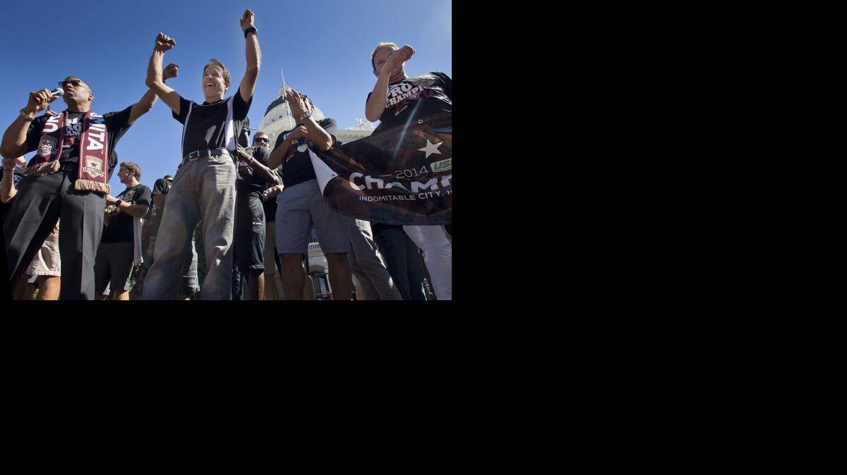 
Sacramento Mayor Kevin Johnson, left, Republic FC head coach Preki and team members rally in support of the Sacramento Republic FC soccer team in Sacramento on Oct. 3. The Republic FC celebrated their 2014 USL Pro championship.
