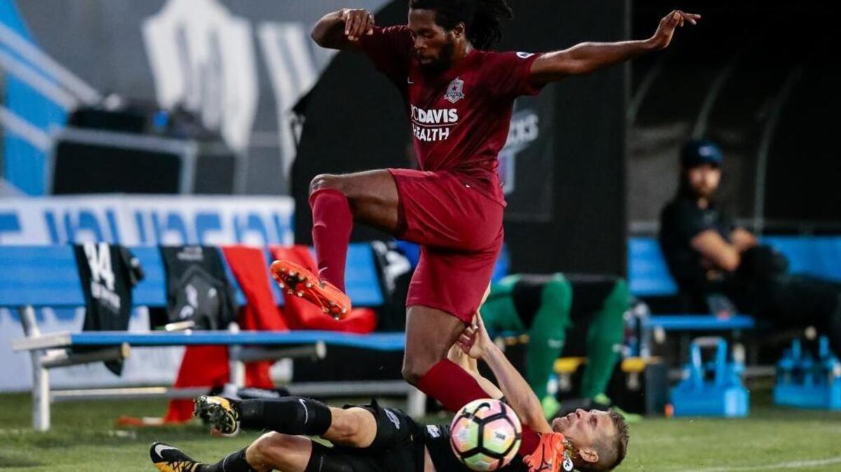 Republic FC defender Chris Christian leaps over Colorado Springs Switchbacks FC midfielder Luke Vercollone while battling for the ball in the first half at Weidner Field. Sacramento lost the road game 1-0.
