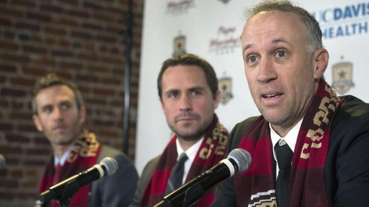 Republic FC coach Simon Elliott, seen at right during his introduction Feb. 1, liked what he saw Thursday despite a 3-1 loss to Major League Soccer team Seattle Sounders FC.
