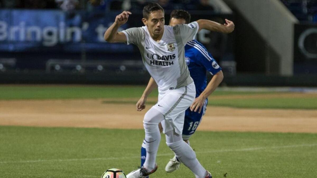 Republic FC defender James Kiffe, front, tries to escape Reno 1868 FC defender Brent Richards on Saturday in Reno. The teams drew 2-2 in the regular-season finale.