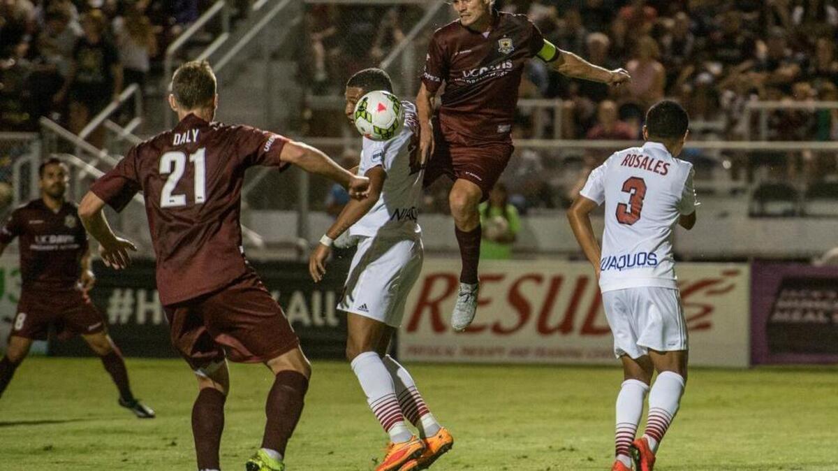 
Republic FC forward Justin Braun, middle, and defender Mickey Daly, left, fight for the ball during the first half Saturday against Arizona at Bonney Field.
