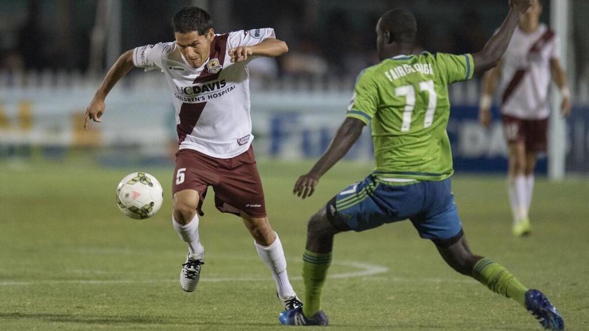 Republic FC midfielder Danny Barrera (5) works the ball past Seattle Sounders FC II defender Ashani Fairclough (77) at Bonney Field in Sacramento on Saturday.
