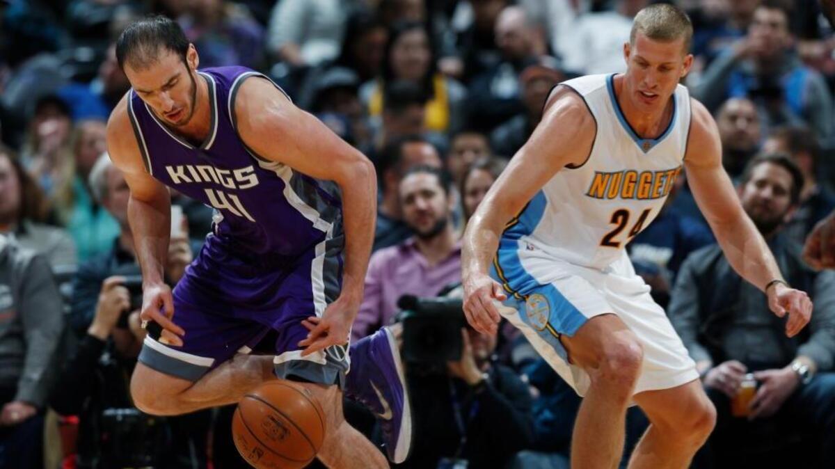 Sacramento Kings center Kosta Koufos, left, steals the ball from Denver Nuggets center Mason Plumlee during an NBA basketball game Monday, March 6, 2017, in Denver. The Nuggets won 108-96.