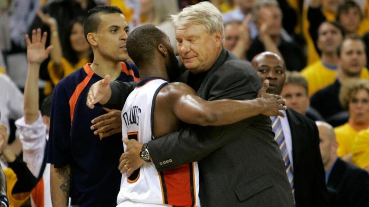 Golden State Warriors guard Baron Davis hugs coach Don Nelson near the end of Game 3 of the first-round series against the Dallas Mavericks on April 27, 2007. The eighth-seeded Warriors went on to upset the No. 1 Mavericks in six games.