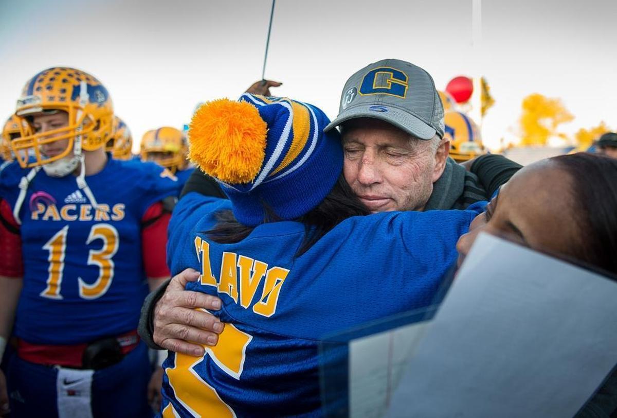 Grant High football coach Mike Alberghini hugs Nicole Clavo, mom of Jaulon “JJ” Clavo, before the Pacers hosted Modesto’s Beyer High in a 2015 Sac-Joaquin Section Division II first-round playoff game.