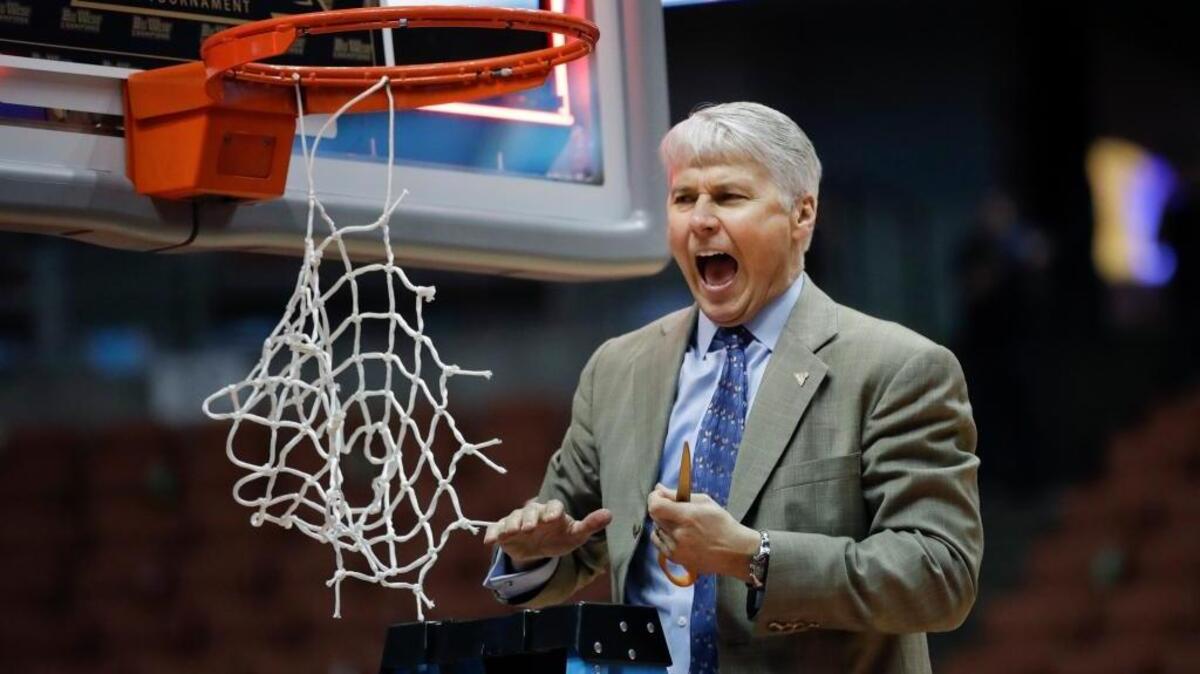 UC Davis head coach Jim Les prepares to cut the net after the Aggies' 50-47 win against UC Irvine on March 11 in Anaheim. UC Davis won the Big West Tournament title to reach the NCAA Tournament for the first time in program history.