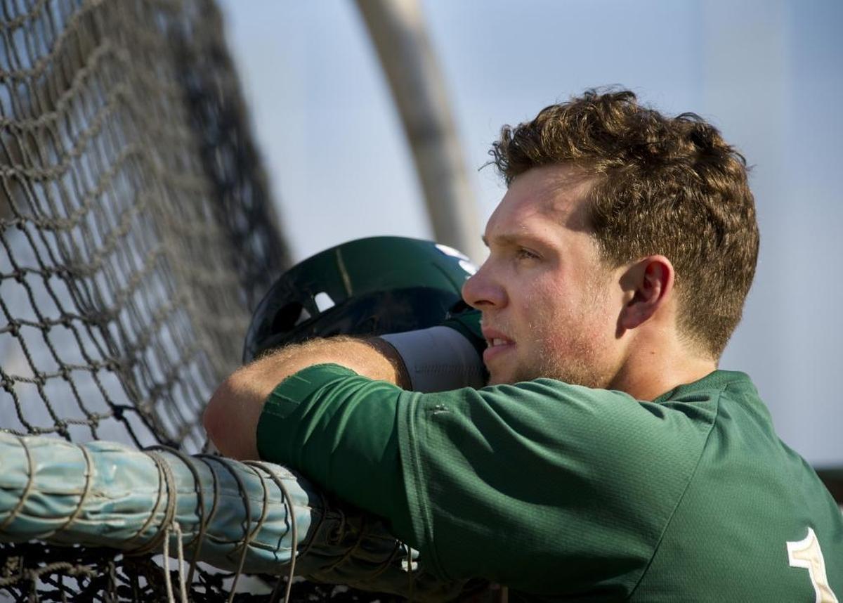 Rhys Hoskins watches a batter from behind the batting cage during practice at Sacramento State in 2014. Hoskins was drafted by the Philadelphia Phillies in 2014 and now plays for the Milwaukee Brewers.