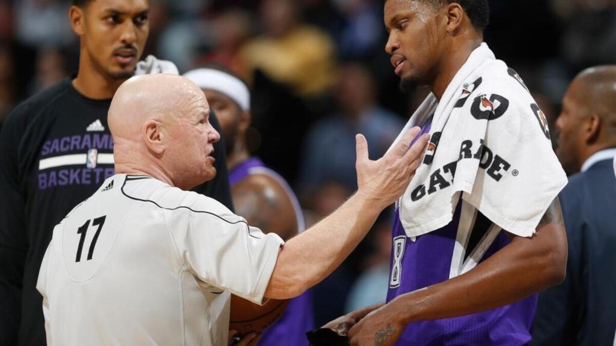 Referee Joey Crawford, left, talks with Sacramento Kings forward Rudy Gay, right, during an NBA basketball game, Monday, Nov. 3, 2014 in Denver.