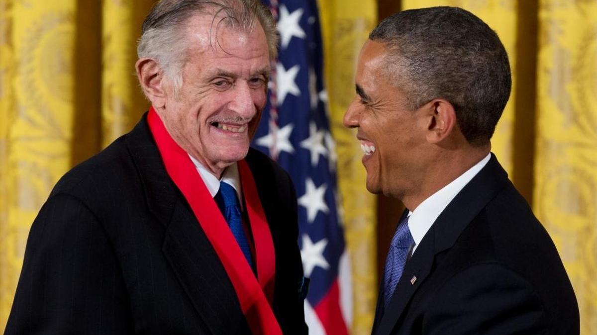 Legendary sportswriter Frank Deford, left, is awarded the National Humanities Medal by President Barack Obama on July 10, 2013. Deford died Sunday in Key West, Fla. He was 78.