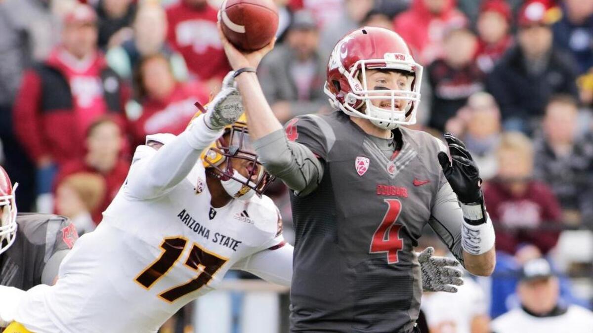 Washington State quarterback Luke Falk (4) passes as he is hit by Arizona State linebacker Ismael Murphy-Richardson (17) during the first half of an NCAA college football game, Saturday, Nov. 7, 2015, in Pullman, Wash.