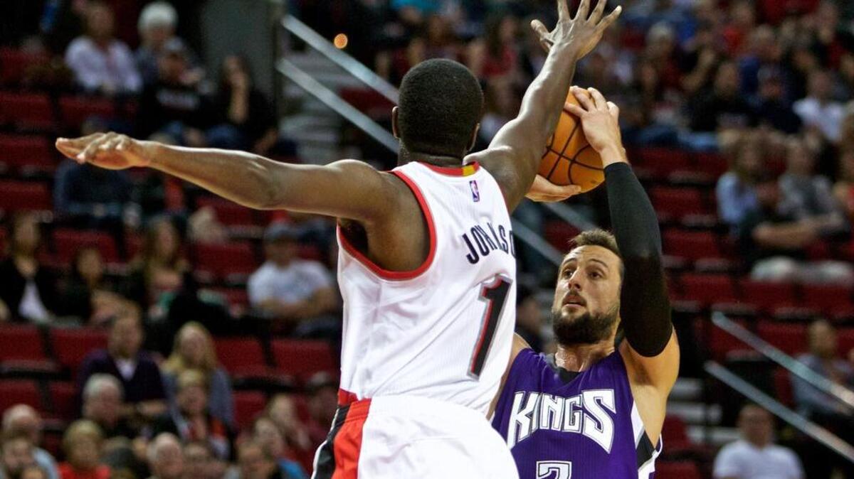 
Sacramento Kings guard Marco Belinelli, right, shoots over Portland Trail Blazers forward Omari Johnson during the second half in Portland, Ore., Monday, Oct. 5, 2015. 
